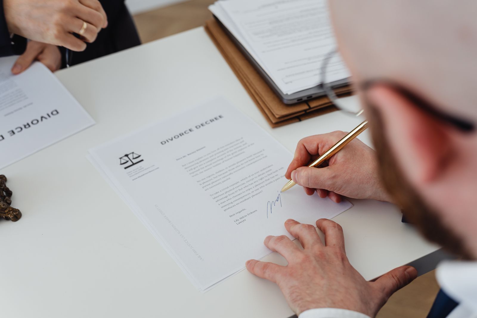 Mortgage documents and a pen on a closing table